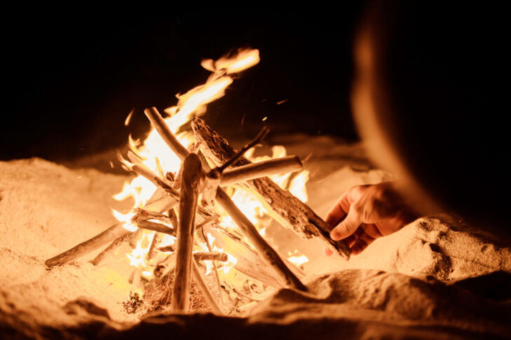 tourist makes fire beach