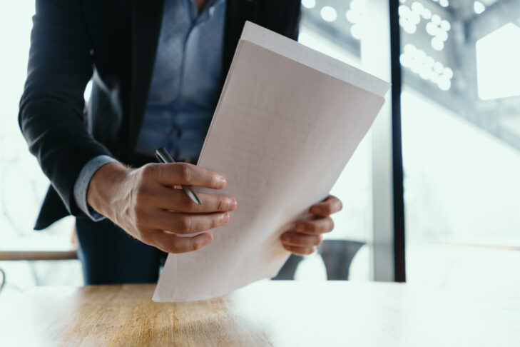 successful business man signing documents modern office scaled