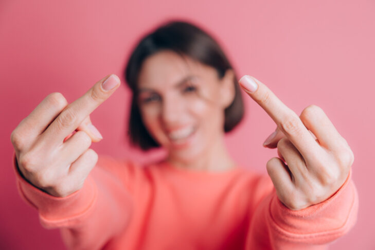 woman wearing casual sweater background showing middle finger doing bad expression provocation rude attitude 1