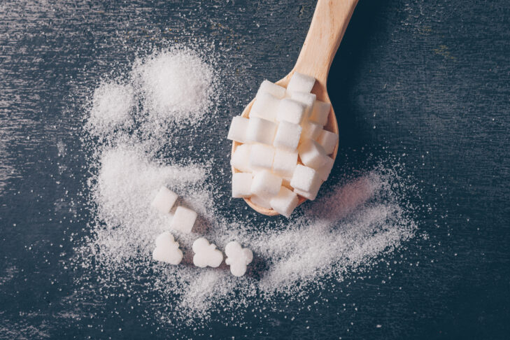 some white sugar spoon flat lay